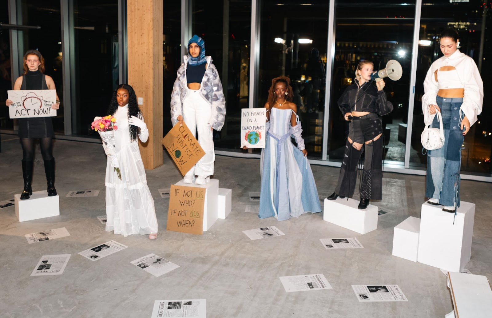 Photo of RéELLE fashion presentation replicating a protest amidst climate change.