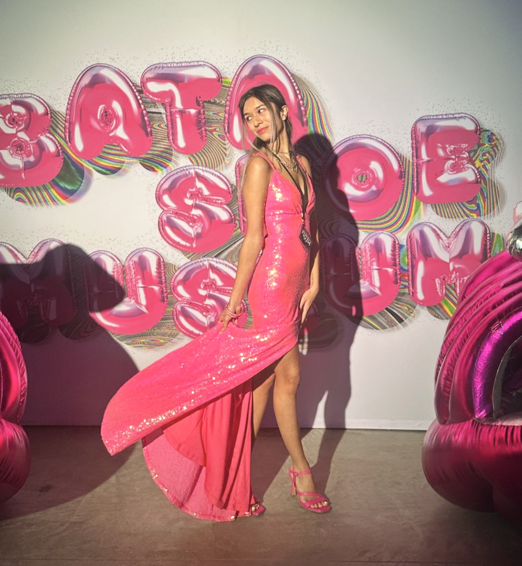 Photo of journalist Aliya Karimjee is in front of the backdrop of the Bata Shoe Museum.