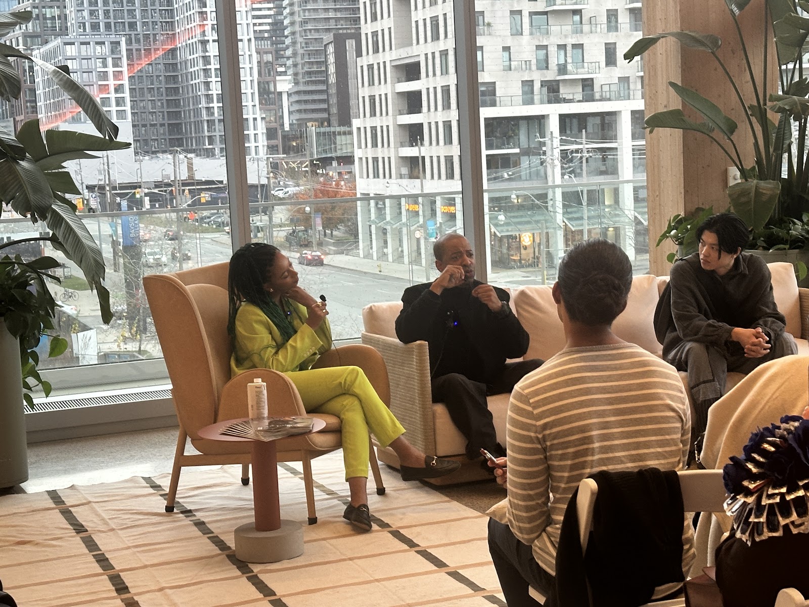 Journalist Hillary Leblanc, designer George Sully, and a photographer conversing at the Runway to Retail panel.
